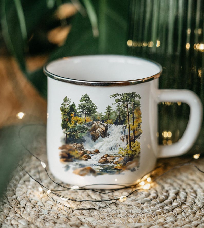 a coffee cup with a picture of a waterfall on it