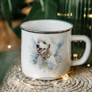 A white ceramic mug with a picture of a poodle on it, placed on a woven mat with twinkling lights in the background.