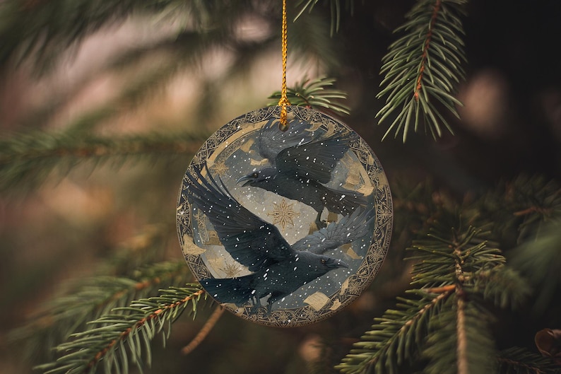 A circular ornament with a bird design hangs from a tree branch.