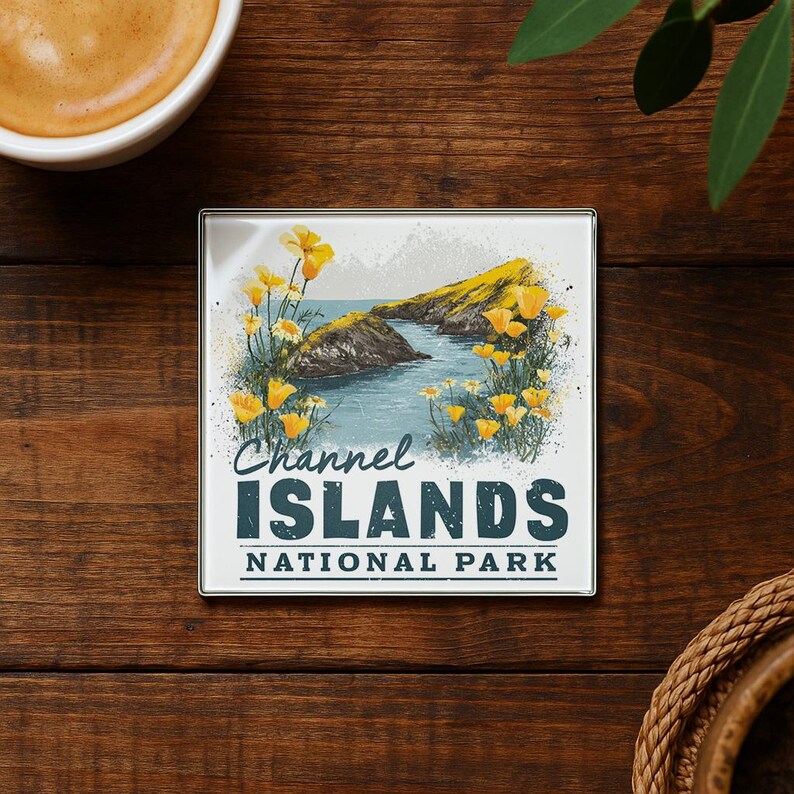 A coaster with a scenic image of the Channel Islands National Park, featuring a rocky coastline, water, and yellow flowers.