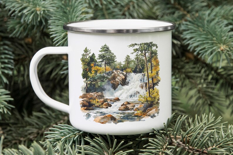 a white coffee mug with a picture of a waterfall on it