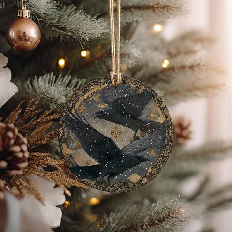 a Christmas tree decorated with ornaments, including a circular ornament with a bird design and a gold and black ornament.