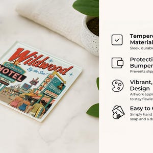 a retro-style coaster with a vintage motel advertisement, placed on a white marble surface next to a glass of water and a potted plant.