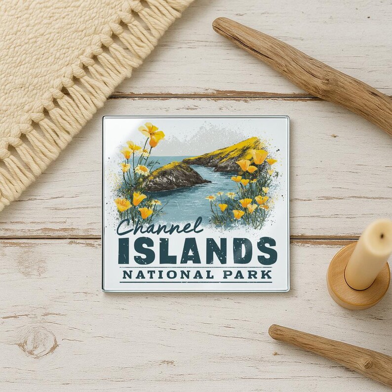 A coaster featuring a scenic image of the Channel Islands National Park, with yellow flowers and a rocky coastline in the background.