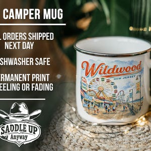 a 17oz ceramic mug with a printed design of a ferris wheel and beach scene, placed on a woven mat.