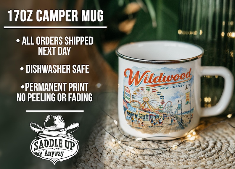 a 17oz ceramic mug with a printed design of a ferris wheel and beach scene, placed on a woven mat.
