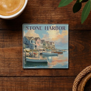 May include: Square glass coaster featuring a coastal scene of Stone Harbor, with colorful houses, boats, and the text "STONE HARBOR". The artwork depicts a serene waterfront with a pastel sky and calm water.