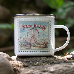 a white coffee mug with a picture of a ferris wheel on it