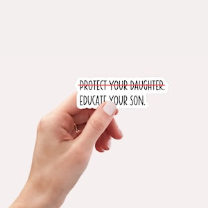 May include: White sticker with black text that reads "PROTECT YOUR DAUGHTER. EDUCATE YOUR SON." with a red line drawn through the word "PROTECT".