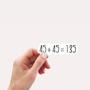 May include: A white sticker with black text that reads "45 + 45 = 135".