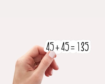 May include: A white sticker with black text that reads "45 + 45 = 135".