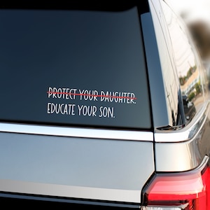May include: A car window sticker with the text "PROTECT YOUR DAUGHTER. EDUCATE YOUR SON." with a red line drawn through the first line.