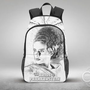 May include: Black and white backpack featuring a portrait of the Bride of Frankenstein. The design is a sketch-like illustration with the text "The Bride of Frankenstein" at the bottom. The backpack has black straps and side pockets.