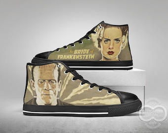May include: Pair of high-top canvas sneakers featuring a vintage-style illustration of the Bride of Frankenstein and Frankenstein's monster. The sneakers have black soles, laces, and toe caps, with the text "The Bride of Frankenstein".
