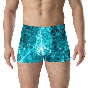 May include: Blue boxer shorts with a white and blue abstract pattern of circles and lines.