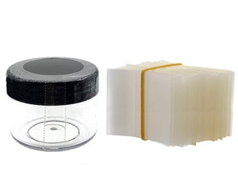 May include: A clear plastic jar with a black lid and a stack of clear plastic sheets secured with a yellow rubber band.