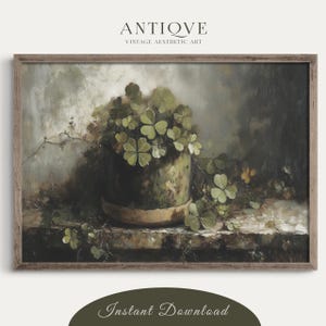 May include: A vintage painting of a potted plant with green leaves against a muted background. The plant is in a green and brown pot with a light brown rim. The painting has a soft, muted color palette and a vintage aesthetic.