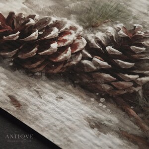 May include: A close-up of a pine cone covered in snow. The cone is brown and has a rough texture. The snow is white and fluffy. The background is blurred and out of focus.