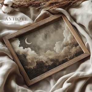 May include: A framed print featuring a night sky scene with a crescent moon, stars, and fluffy clouds in shades of brown and gray. The wooden frame has a natural finish. The text "ANTIQVE VINTAGE AESTHETIC ART" is printed at the top.