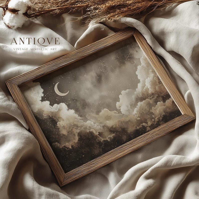 May include: A framed print featuring a night sky scene with a crescent moon, stars, and fluffy clouds in shades of brown and gray. The wooden frame has a natural finish. The text "ANTIQVE VINTAGE AESTHETIC ART" is printed at the top.