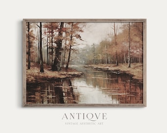 May include: A framed painting of a forest scene with a river winding through it. The trees are in shades of brown, orange, and red, and the water is a deep blue. The painting is in a rustic wooden frame.