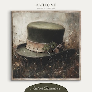 May include: An antique-style digital art print featuring a green top hat with a cream-colored band and shamrock accents. The hat sits in a field of wildflowers. The print is framed and has the text "ANTIQVE VINTAGE AESTHETIC ART" at the top and "Instant Download" at the bottom.