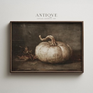 May include: A framed vintage aesthetic art print featuring a still life of a white pumpkin with a curved stem and dried leaves. The artwork is set against a dark background, with the text "ANTIOVE VINTAGE AESTHETIC ART" at the top.