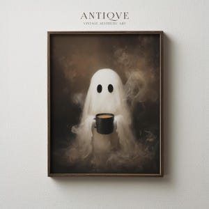 May include: A framed print featuring a whimsical ghost holding a black mug with a brown liquid. The ghost is white with two black oval eyes, set against a smoky, sepia-toned background. The print is labeled "ANTIQVE VINTAGE AESTHETIC ART".