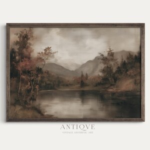 May include: A framed vintage landscape painting featuring a serene lake reflecting the surrounding trees and mountains. The artwork is rendered in muted tones of brown, gray, and beige, with the word "ANTIQVE" and "VINTAGE AESTHETIC ART" printed at the bottom.