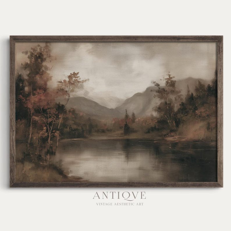 May include: A framed vintage landscape painting featuring a serene lake reflecting the surrounding trees and mountains. The artwork is rendered in muted tones of brown, gray, and beige, with the word "ANTIQVE" and "VINTAGE AESTHETIC ART" printed at the bottom.