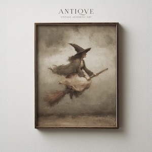 May include: Framed vintage aesthetic art print featuring a witch flying on a broomstick. The artwork is in muted tones of brown, beige, and gray, with the word "ANTIQVE" at the top. The witch is wearing a pointed hat and flowing robes.