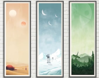 May include: Three framed prints depicting different Star Wars landscapes. The first print shows a desert scene with two suns in the sky. The second print shows a snowy scene with an AT-AT walker. The third print shows a forest scene with a Death Star in the sky.
