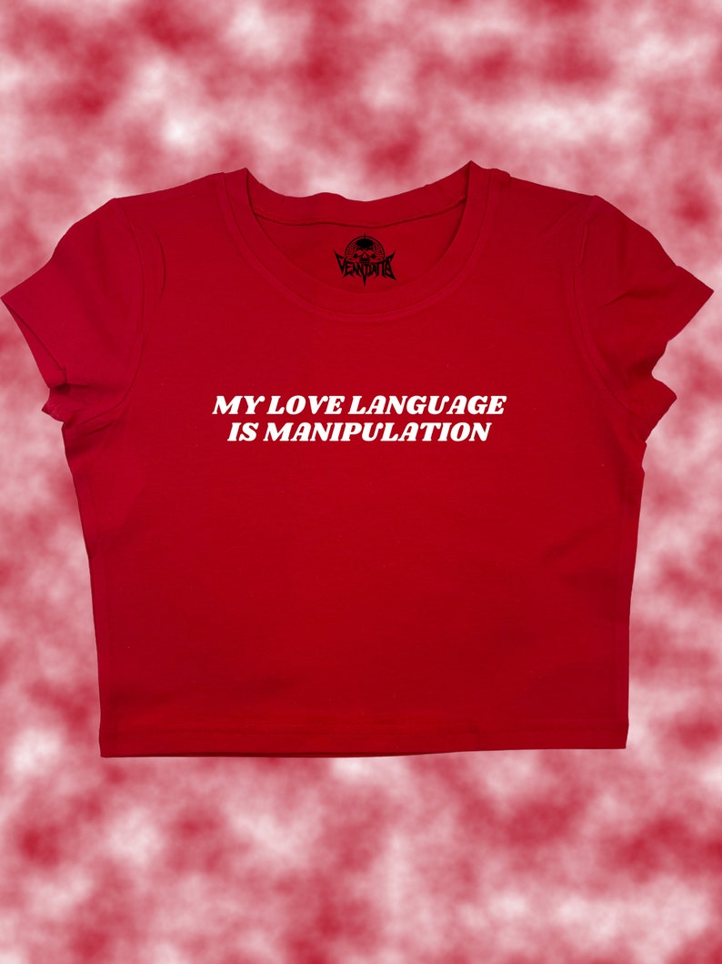 May include: Red cropped t-shirt with white text that reads "My love language is manipulation."