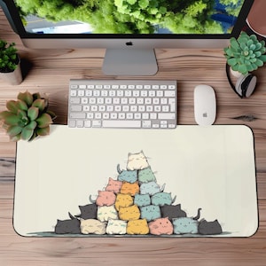 May include: A beige mouse mat with a colourful illustration of a pyramid of cats. The cats are stacked on top of each other and are all different colours. The mouse mat is a great way to add some personality to your desk.