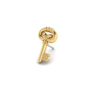 May include: A gold-colored key-shaped earring with a decorative top and a simple keyhole design. The earring has a post for insertion and is set against a white background. The key is a classic design.