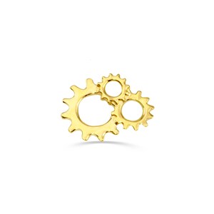 May include: Three gold-colored interlocking gears, a decorative design element.