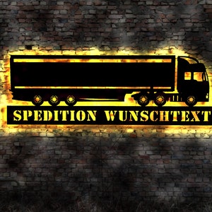 May include: A yellow neon sign with a black silhouette of a lorry and the text "SPEDITION WUNSCHTEXT".