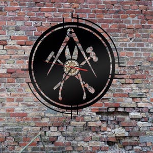 May include: A black metal clock with a circular design featuring a compass, pliers, a hammer, and a screwdriver. The clock face is visible with red hands.