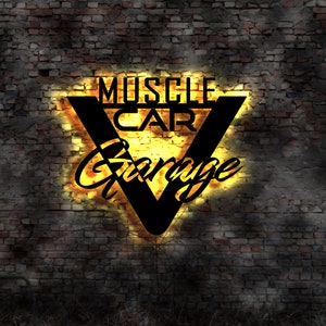May include: A neon sign with a black V shape and the words "Muscle Car Garage" in yellow letters on a brick wall background.