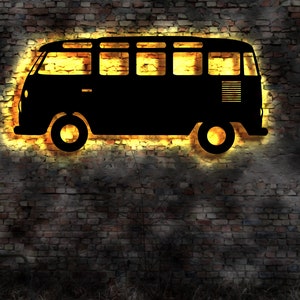 May include: A black silhouette of a vintage van with a yellow glow around it, set against a brick wall background.