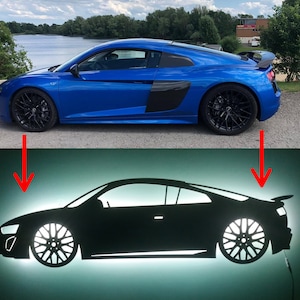 May include: A blue sports car with black accents and black wheels. The car is a silhouette of a car with a white light behind it.
