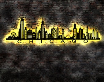 May include: Black metal silhouette of the Chicago skyline with the word "CHICAGO" in large letters below. The silhouette is illuminated with a yellow glow against a brick wall background.