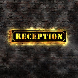 May include: A black sign with yellow lettering that reads "RECEPTION" is mounted on a brick wall. The sign is illuminated with a warm yellow glow.