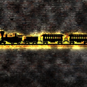 May include: A black silhouette of a train engine and two passenger carriages against a brick wall background. The train is illuminated with a warm yellow glow.