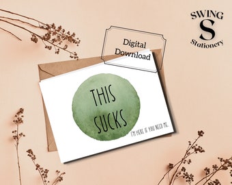 May include: A printable card with a green watercolor circle and the text "This Sucks" in black. The card also includes the text "I'm here if you need me."