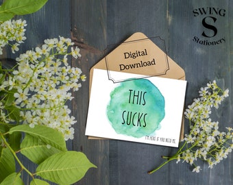 May include: A digital download card with a watercolor background in shades of blue and green. The card says "This Sucks" in black text and "I'm here if you need me." in smaller black text.