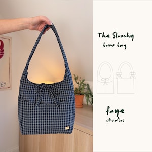 May include: A blue and white check shoulder bag with a bow detail. The bag has a curved shape and a long strap. The text "The Slouchy bow bag" and "faye studios" are visible.