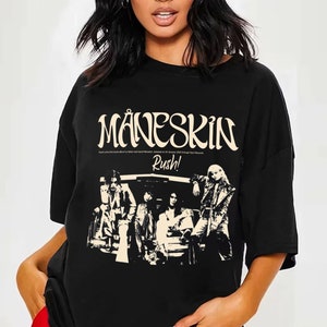 May include: Black t-shirt with a white graphic print of the band M&aring;neskin. The graphic includes the band's name, the album title "Rush!" and a black and white image of the band members.