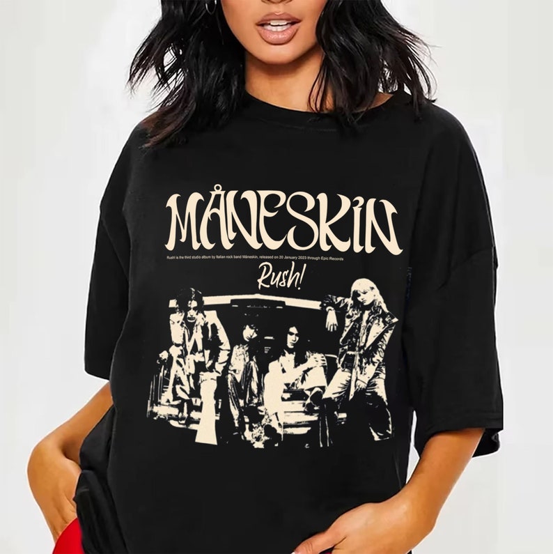 May include: Black t-shirt with a white graphic print of the band M&aring;neskin. The graphic includes the band's name, the album title "Rush!" and a black and white image of the band members.
