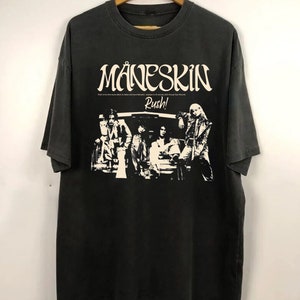 May include: Black t-shirt with a white graphic of the band M&aring;neskin. The graphic includes the band's name, the word "Rush!" and a silhouette of the band members.